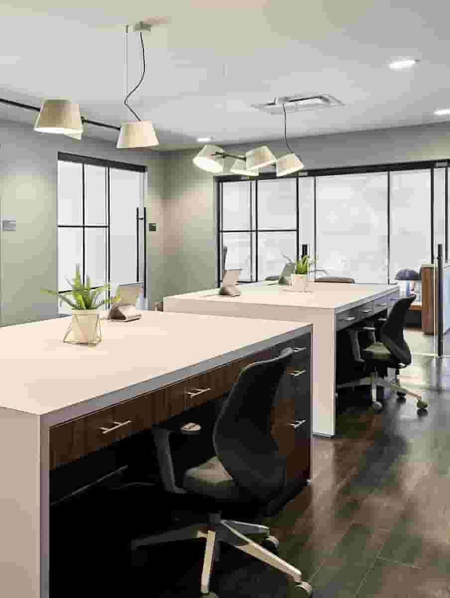 Collab desks with private meeting rooms in the background