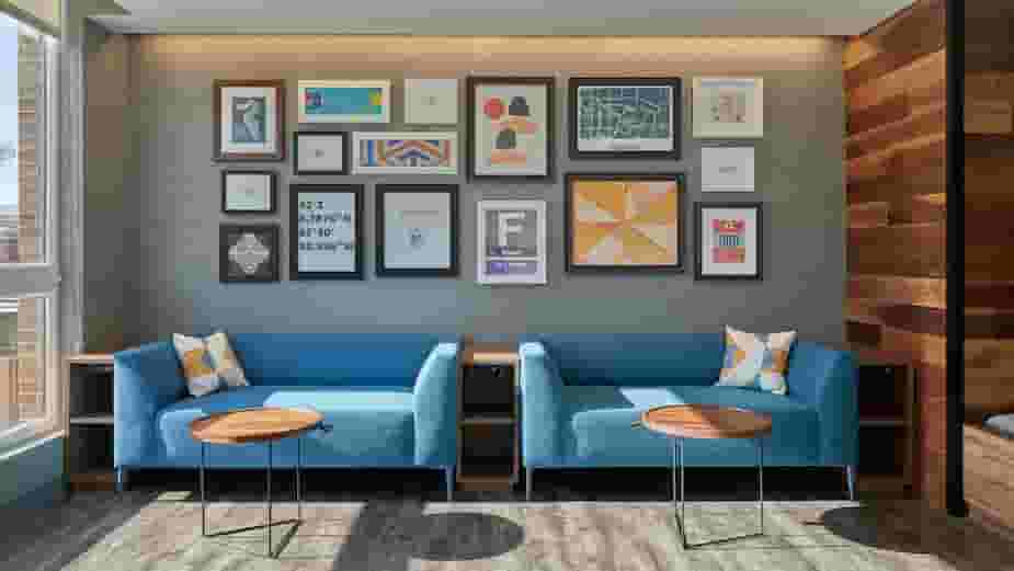 Blue couches with artwork in the Game Lounge